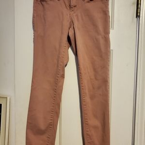 Salmon colored skinny jeans.